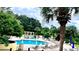 Scenic pool with lounge chairs, umbrellas, and green landscaping, perfect for relaxing at 1400 Lake Shadow Cir # 10105, Maitland, FL 32751