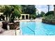 Inviting community pool with lounge chairs and shade, perfect for relaxing outdoors at 1400 Lake Shadow Cir # 10105, Maitland, FL 32751