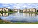 Exterior view of yellow buildings reflecting off the lake with a fountain at 1400 Lake Shadow Cir # 10105, Maitland, FL 32751