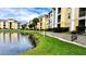 Exterior view of yellow buildings near a lake with manicured landscaping at 1400 Lake Shadow Cir # 10105, Maitland, FL 32751