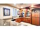 This home features a kitchen with granite countertops, wood cabinetry, a wine rack, and stainless steel appliances at 1400 Lake Shadow Cir # 10105, Maitland, FL 32751