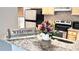 Open kitchen featuring granite countertops, stainless steel appliances, and natural wood cabinets at 1400 Lake Shadow Cir # 10105, Maitland, FL 32751