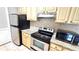 Updated kitchen features stainless steel appliances, granite countertops, and natural wood cabinets at 1400 Lake Shadow Cir # 10105, Maitland, FL 32751