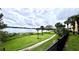 Beautiful lake view from well-maintained lawn with mature trees, plants, and walking path at 1400 Lake Shadow Cir # 10105, Maitland, FL 32751