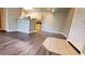 A cozy living room features wood-look flooring and seamlessly connects to a kitchen with light wood cabinets at 1400 Lake Shadow Cir # 10105, Maitland, FL 32751