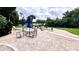 Open patio with furniture, umbrellas, and lake view at 1400 Lake Shadow Cir # 10105, Maitland, FL 32751