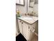A well-lit vanity features granite countertops, a modern faucet, and dark hardware at 1400 Lake Shadow Cir # 10105, Maitland, FL 32751