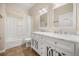 Bright bathroom with double sink vanity, large mirror, and tub with shower at 14645 Tullamore Loop, Winter Garden, FL 34787
