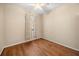 A comfortable bedroom with hardwood floors, neutral walls, and lots of natural light at 14645 Tullamore Loop, Winter Garden, FL 34787