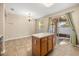 Bright kitchen featuring an island, sliding glass doors to the patio, and tile flooring at 14645 Tullamore Loop, Winter Garden, FL 34787