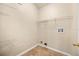 A small laundry room with tile floors and shelving at 14645 Tullamore Loop, Winter Garden, FL 34787