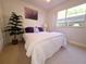 Inviting bedroom with a comfy bed, lush indoor plant, and ample natural light at 1600 W Lake Parker Dr # D5, Lakeland, FL 33805