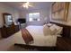 Comfortable bedroom with ceiling fan, two dressers, painting and a large window at 1600 W Lake Parker Dr # D5, Lakeland, FL 33805