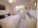 Bright bedroom with a large window, comfortable bed, and a stylish dresser at 1600 W Lake Parker Dr # D5, Lakeland, FL 33805