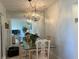 Open dining room features glass table, seating for four and decorative chandelier at 1600 W Lake Parker Dr # D5, Lakeland, FL 33805
