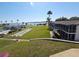 Scenic view of waterfront community with lush lawns, shuffleboard court, and mature palm trees along the water at 1600 W Lake Parker Dr # D5, Lakeland, FL 33805