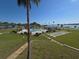 Scenic elevated view of lush lawns, community pool, shuffleboard court, and waterfront at 1600 W Lake Parker Dr # D5, Lakeland, FL 33805