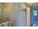 Hallway leading to the bedroom and bathroom with tiled flooring and white walls at 1600 W Lake Parker Dr # D5, Lakeland, FL 33805