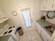 Cozy kitchen with white cabinets, appliances, and access to the outside at 1600 W Lake Parker Dr # D5, Lakeland, FL 33805