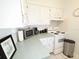 Bright kitchen featuring white cabinets, tiled backsplash, and modern appliances at 1600 W Lake Parker Dr # D5, Lakeland, FL 33805