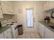 Charming kitchen featuring white cabinets, appliances, and access to the outside at 1600 W Lake Parker Dr # D5, Lakeland, FL 33805