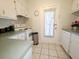Bright kitchen with white cabinets, appliances, and outside access at 1600 W Lake Parker Dr # D5, Lakeland, FL 33805