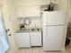 Compact kitchen featuring white appliances, cabinets, and a convenient sink area at 1600 W Lake Parker Dr # D5, Lakeland, FL 33805