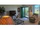 Bright living room boasts a green front door, comfortable seating, and open layout at 1600 W Lake Parker Dr # D5, Lakeland, FL 33805