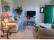 Bright living room showcases a green door, flat-screen TV, and decorative plants at 1600 W Lake Parker Dr # D5, Lakeland, FL 33805