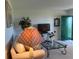 Well-lit living space features a green front door, television, and cozy atmosphere at 1600 W Lake Parker Dr # D5, Lakeland, FL 33805
