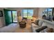 Welcoming living room featuring a green door, plush armchair, and bright window views at 1600 W Lake Parker Dr # D5, Lakeland, FL 33805