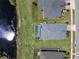 Aerial view of the property with a private screened pool and beautiful views of the adjacent pond at 16781 Meadows St, Clermont, FL 34714