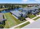 Aerial view showcasing the property and its proximity to a tranquil lake and other residences at 16781 Meadows St, Clermont, FL 34714