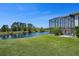 Spacious backyard featuring a screened pool area with a stunning pond view, perfect for outdoor entertainment and relaxation at 16781 Meadows St, Clermont, FL 34714