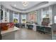 Bright craft room with multiple workstations, natural light from large windows, and ample storage for creative projects at 16781 Meadows St, Clermont, FL 34714