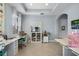 Well-lit craft room with built-in cabinets, multiple work surfaces, and storage solutions, perfect for creative hobbies and projects at 16781 Meadows St, Clermont, FL 34714