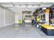 Spacious garage with epoxy flooring, ample storage solutions, and plenty of room for parking and organization at 16781 Meadows St, Clermont, FL 34714