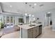 Well-lit kitchen with stainless steel appliances, island seating, and an open layout at 16781 Meadows St, Clermont, FL 34714