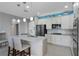 Bright kitchen with granite island, white cabinetry, and stainless steel appliances, perfect for cooking and entertaining at 16781 Meadows St, Clermont, FL 34714