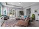 Bright living room featuring a cozy seating area and sliding glass doors leading to the outdoors at 16781 Meadows St, Clermont, FL 34714