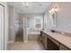Beautiful main bathroom with a soaking tub, walk-in shower, and dual sinks at 16781 Meadows St, Clermont, FL 34714