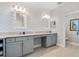 Elegant main bathroom with dual sinks, granite countertops, and custom cabinetry at 16781 Meadows St, Clermont, FL 34714