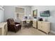 Office space with leather chair, modern desk, and plenty of natural light at 16781 Meadows St, Clermont, FL 34714