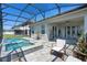 Enclosed patio features an outdoor kitchen, hot tub, and comfortable seating at 16781 Meadows St, Clermont, FL 34714