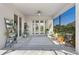 Lovely covered patio featuring stylish tile flooring, potted plants, and ample natural light, perfect for outdoor enjoyment and relaxation at 16781 Meadows St, Clermont, FL 34714