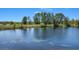 Scenic view of the tranquil pond on the property, showcasing natural beauty and peaceful surroundings at 16781 Meadows St, Clermont, FL 34714