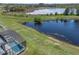Beautiful backyard view with screened in lanai and pool overlooking scenic lake at 16781 Meadows St, Clermont, FL 34714