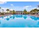 Sparkling community pool with a cabana and plenty of seating for residents to enjoy at 16781 Meadows St, Clermont, FL 34714