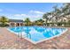 Community pool with lounge chairs, shaded cabana, and well-maintained surroundings at 16781 Meadows St, Clermont, FL 34714