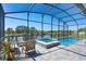 Beautiful screened pool area with lake view, complete with a jacuzzi and outdoor seating, perfect for relaxing and enjoying the scenery at 16781 Meadows St, Clermont, FL 34714